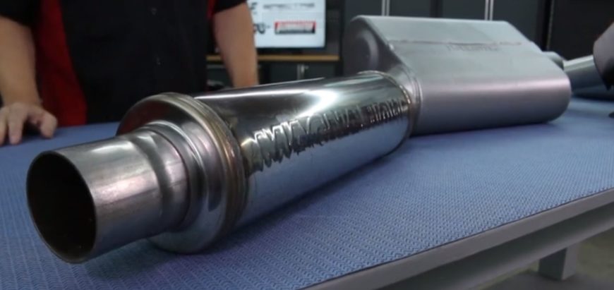 A Magnaflow muffler sitting on top of a shop table.