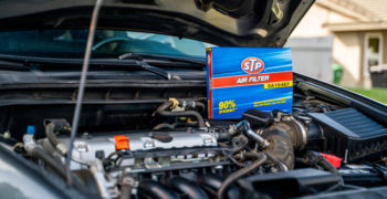 an open engine bay with a box for an STP air filter standing up behind the engine block