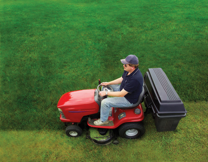 Man riding his lawn mower while thinking about how to change a lawn mower spark plug