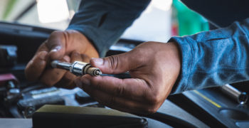 Person reading a spark plug to determine how it has been working