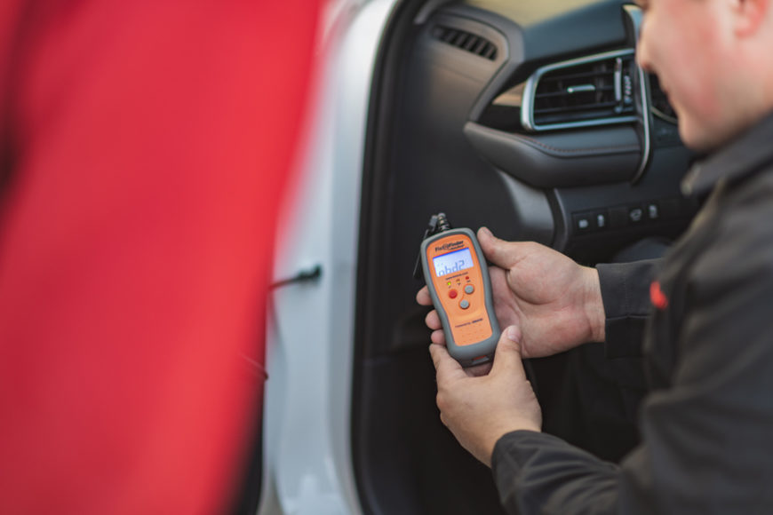 Man scanning a car to determine how to fix a DTC